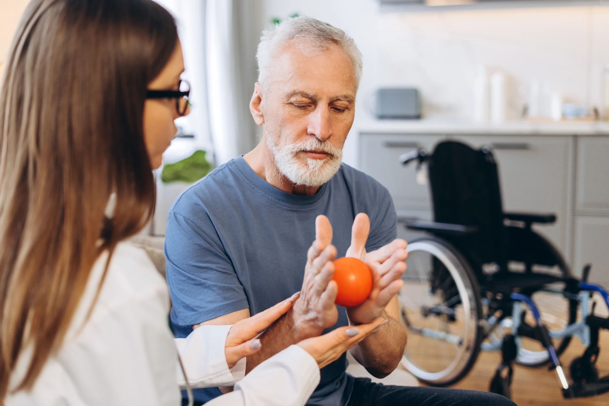 Occupational therapy session — therapist working with patient on fine motor skills
